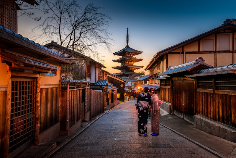 Pagoda rising over a historic Kyoto street at dusk