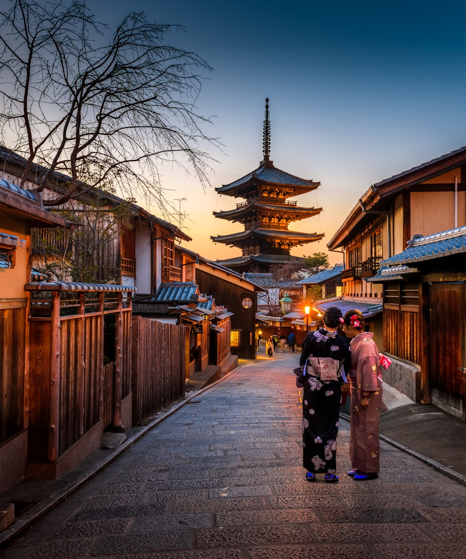 Pagoda rising over a historic Kyoto street at dusk