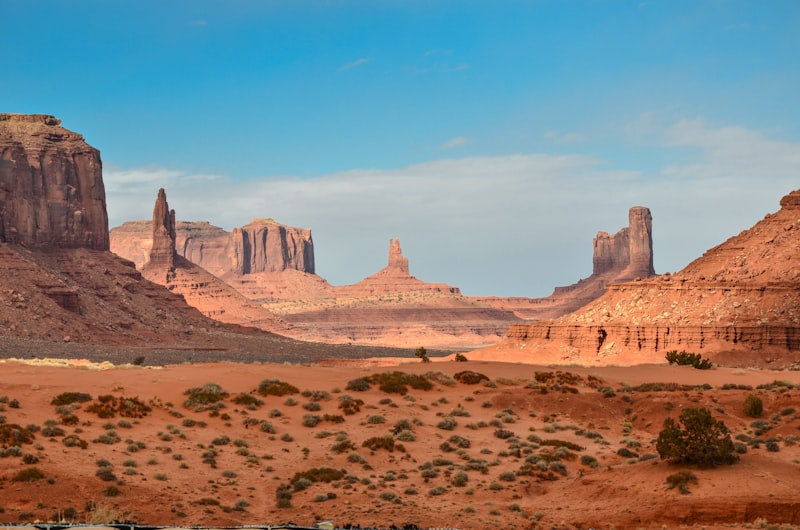 Red-rock desert buttes under a blue sky