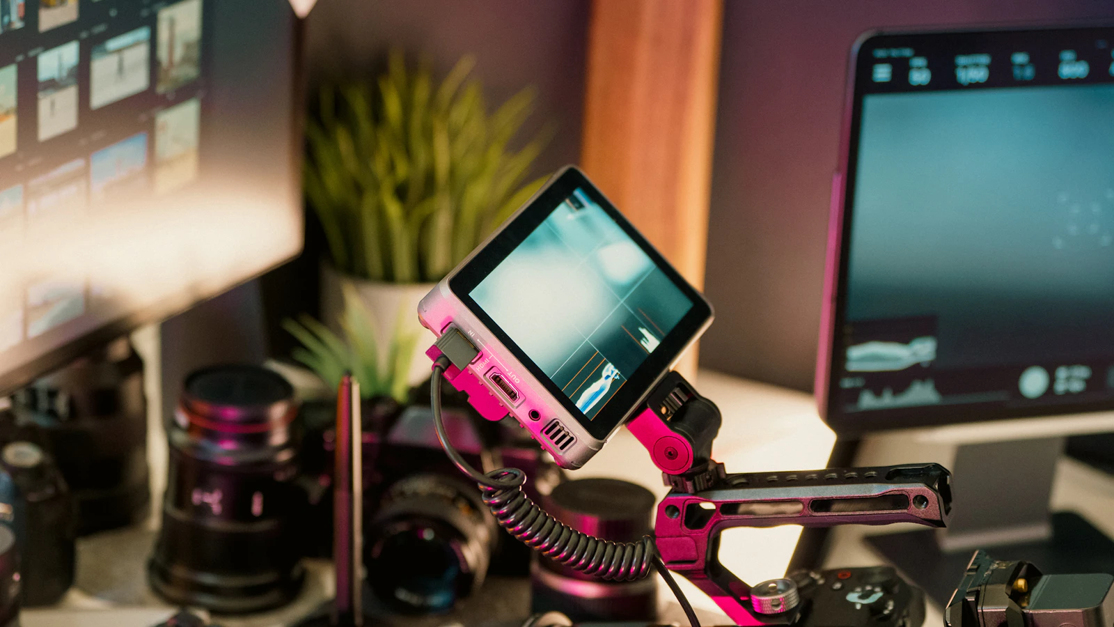 Creator camera rig beside an editing workstation at night