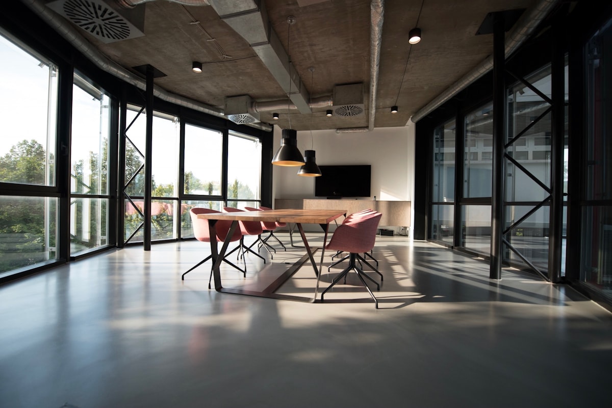 Sunlit office meeting room with designer chairs